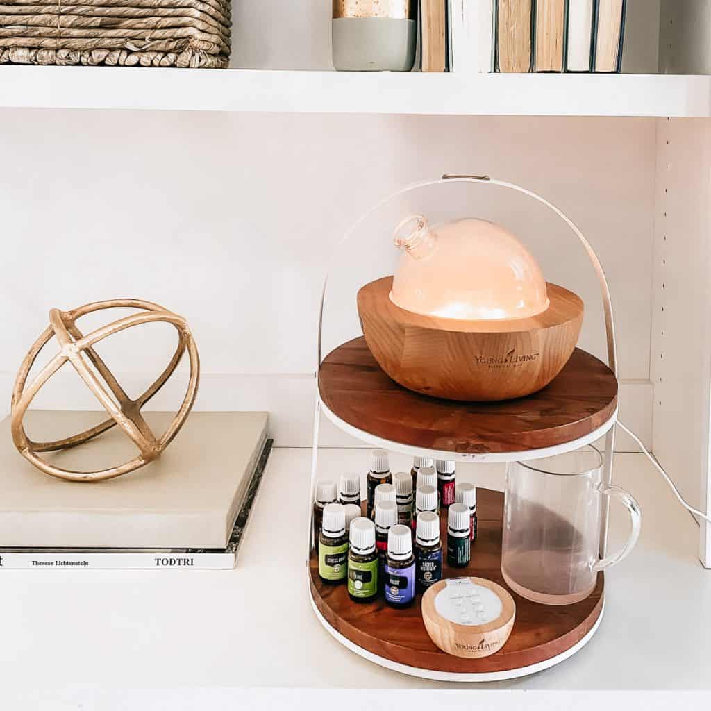 essential oil diffuser on stand with oils around it