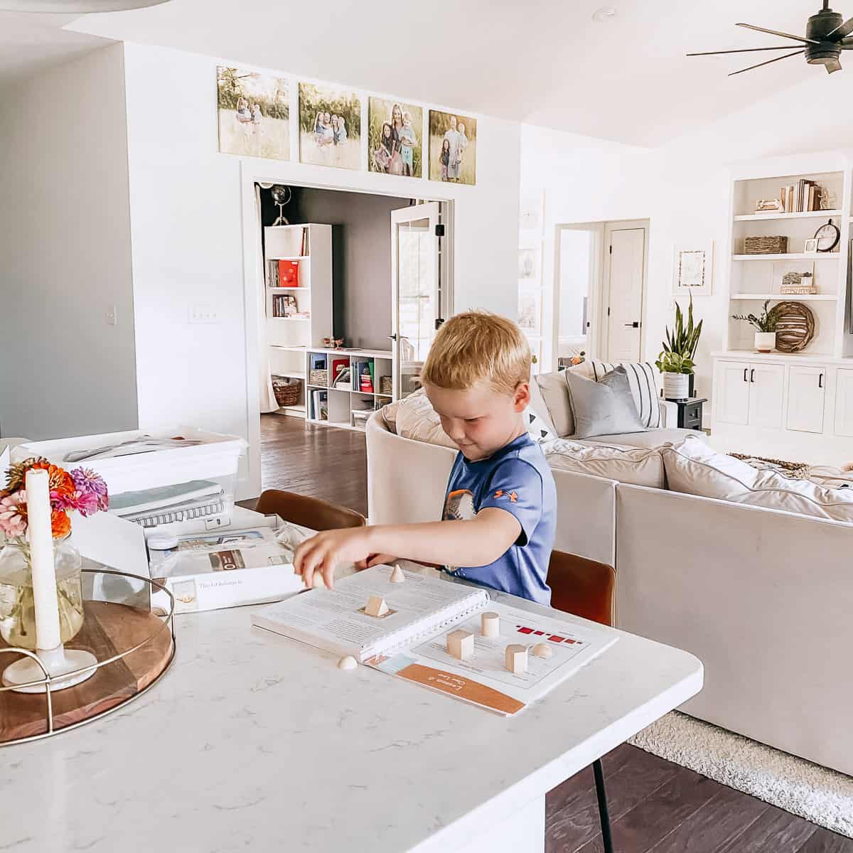 homeschool boy doing math work in the kitchen