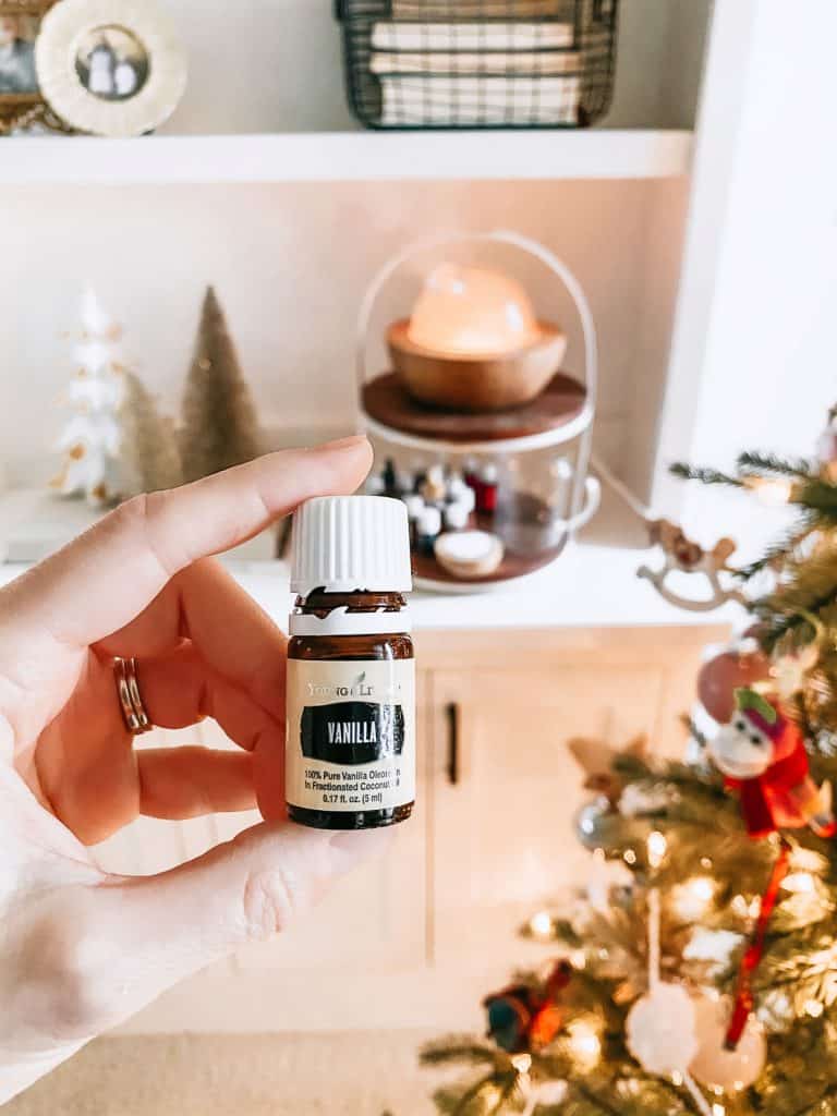 vanilla essential oil in front of diffuser but christmas tree