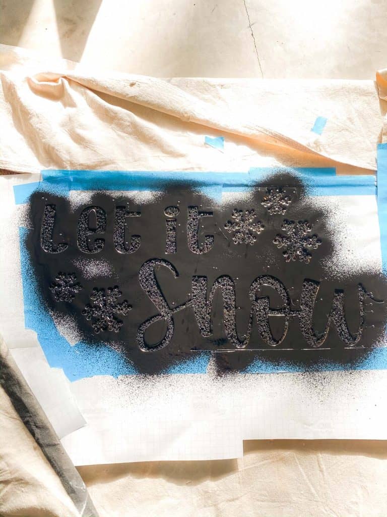 flex seal sprayed over stencil onto doormat