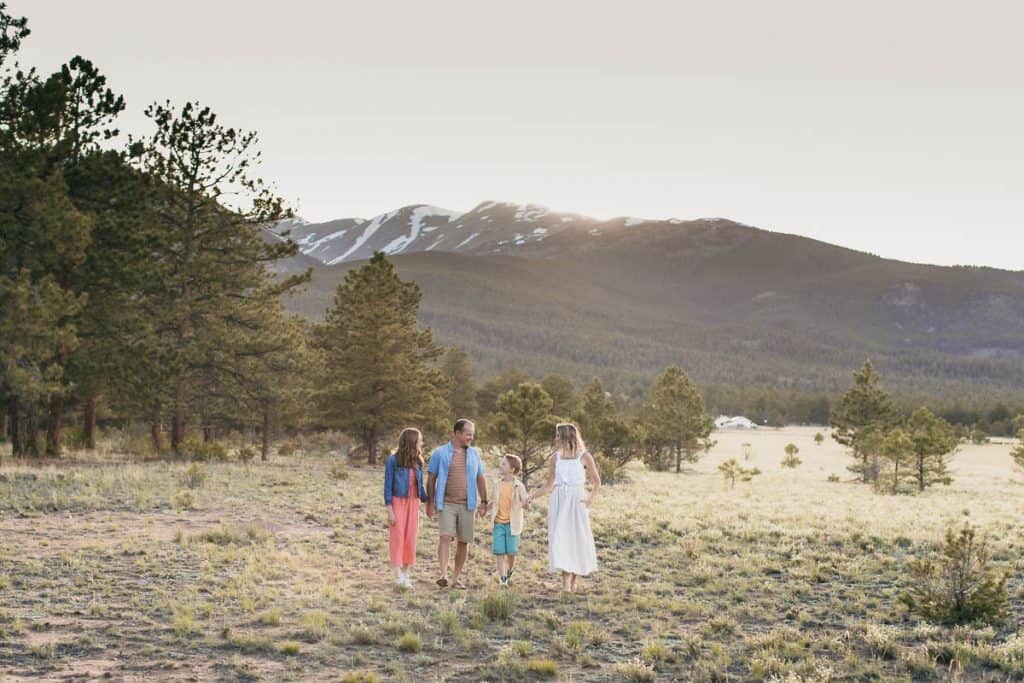 family walking in front of a mountain in colorado